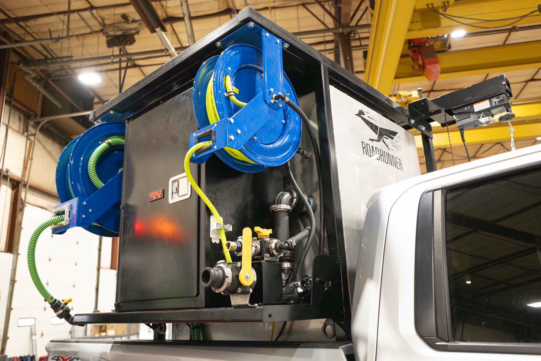 Close-up of the RoadRunner 350 hose reels, plumbing, and mounted tender hardware